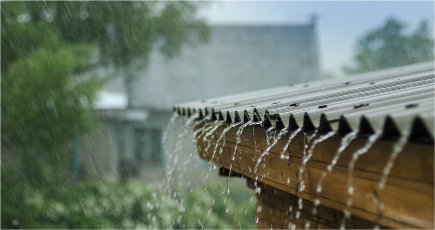 Rainwater dripping off the edge of a roof.