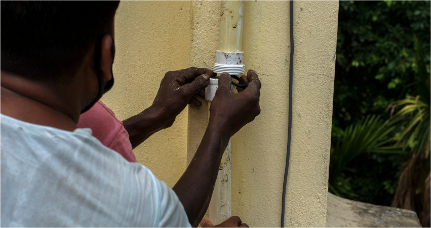 A man working on an outdoor electrical installation.