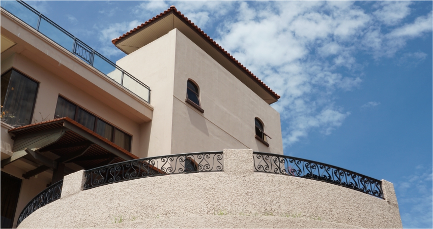 A building with a balcony and wrought iron railing.