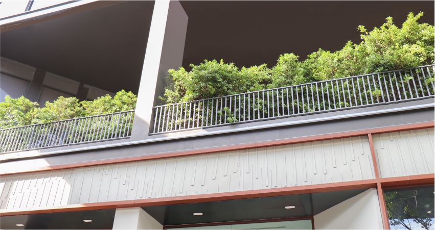 A balcony with pipe grill and plants