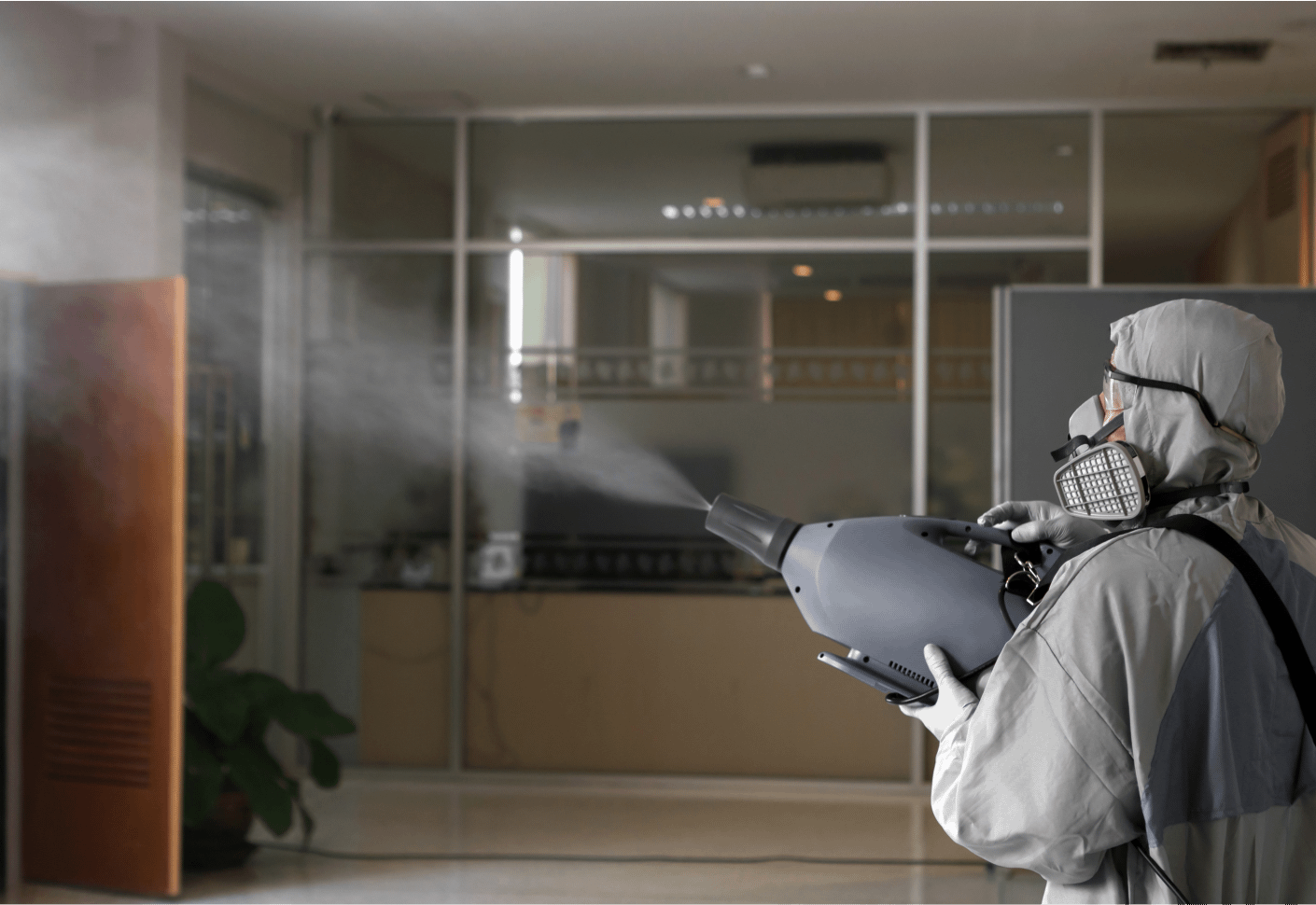 person disinfecting the office and commercial space