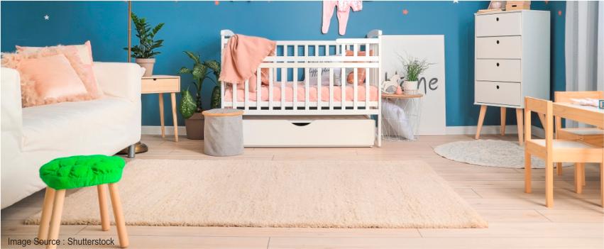 Blue wall with brown flooring and matching furniture in the nursery room