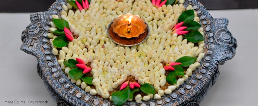 decorating thali with Dia and Flowers during Diwali