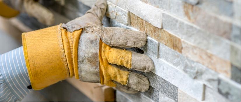 person installing cladding tile