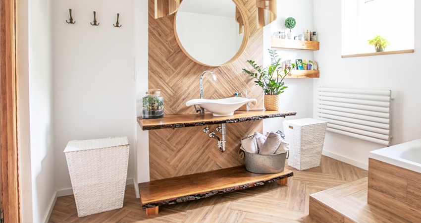 A bathroom with a wooden sink and mirror.