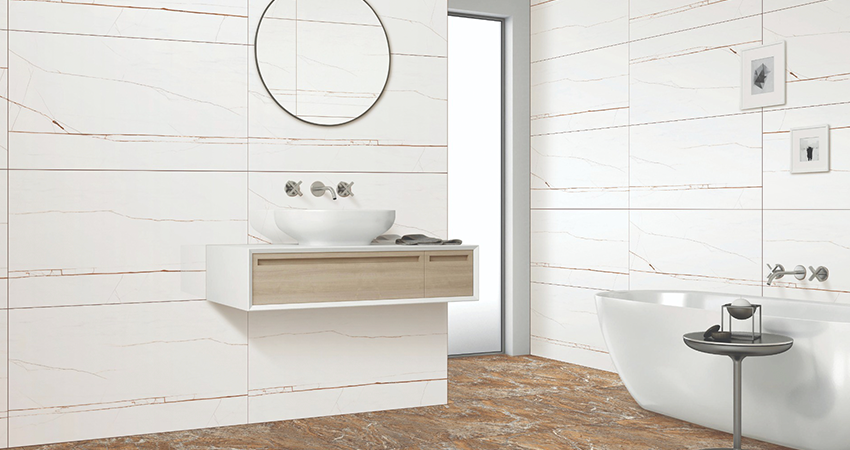 A bathroom with white and brown tiled walls and a bathtub.