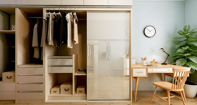 A room with a cupboard and study table for kids.