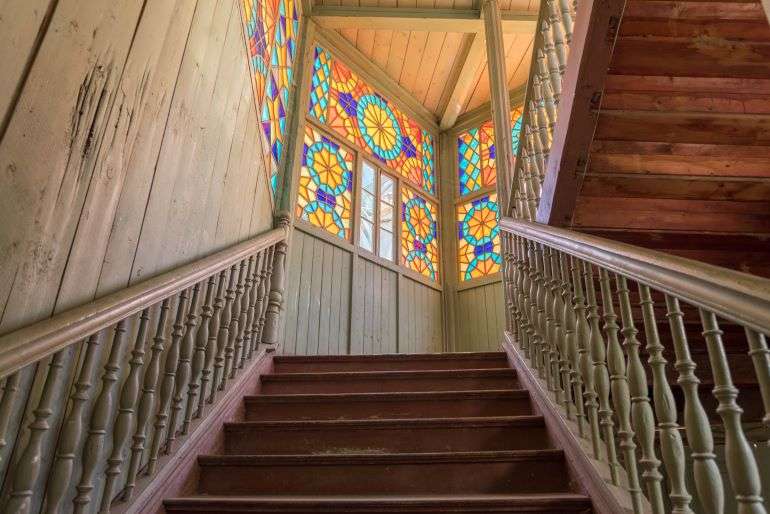 Colourful windows at walll on Wooden Staircase