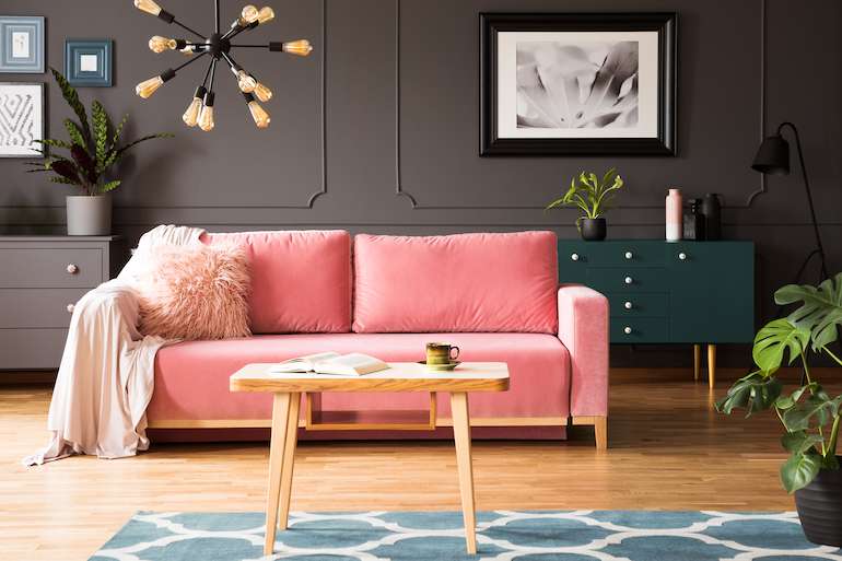 Grey wall with pink couch