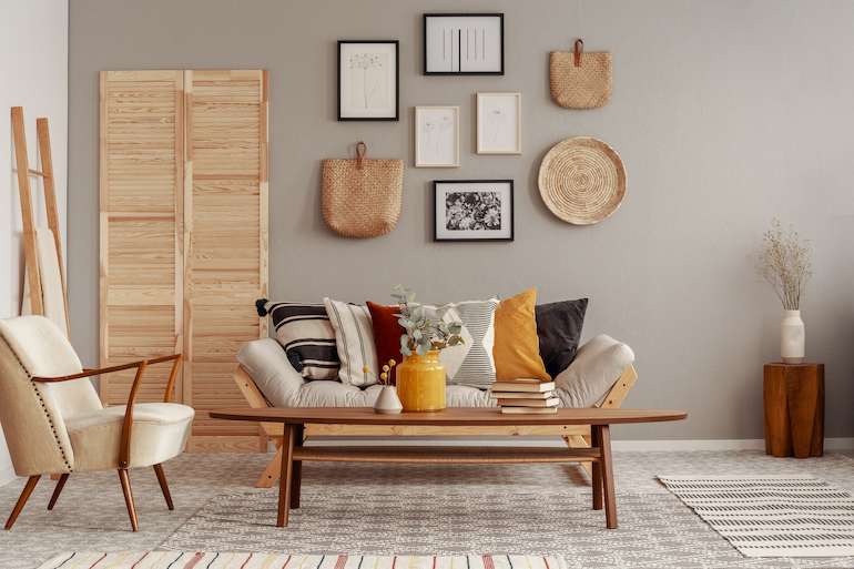 Light Grey Wall with Cream Coloured Couch and Armchair