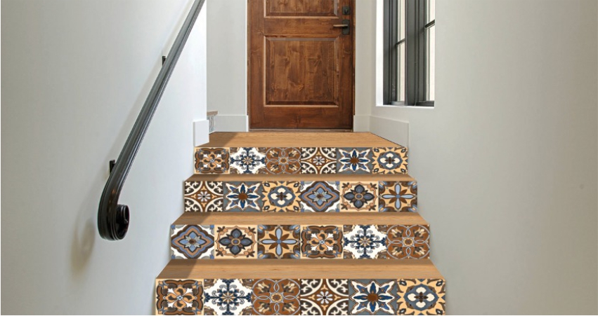 A staircase with traditional motifs tiled steps and a wooden door.