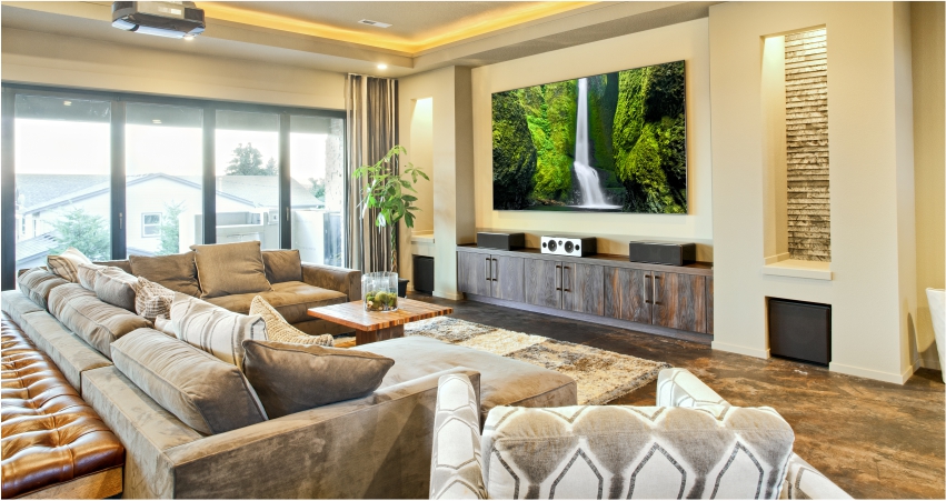 A living room with a large flat screen tv and smart lighting options.