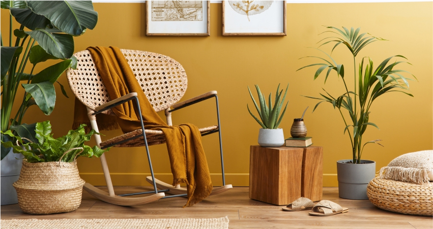 A room with yellow walls and a rocking chair.