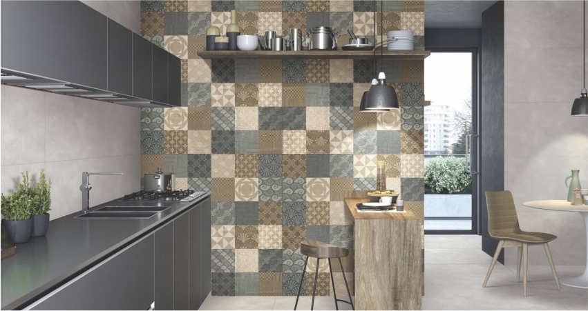A kitchen with a brown and beige tiled wall.