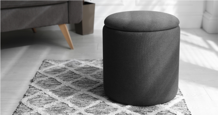 A black storage furniture on a rug in a living room.