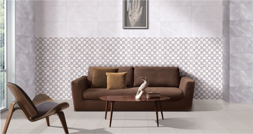 A living room with a brown couch and tiled walls.