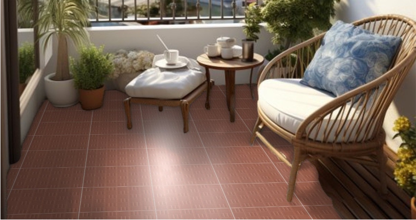 A red terracotta tiled patio with a wicker chair and potted plants.