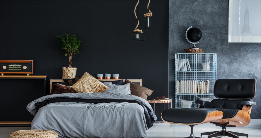 A bedroom with marvellous metal texture design walls and a black chair. 