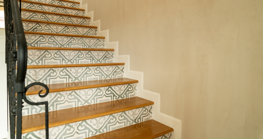 A tiled staircase in a home with a pattern on it.