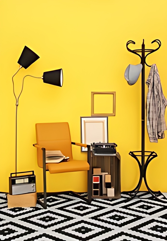 A room with yellow wall, a black and white rug and a chair.