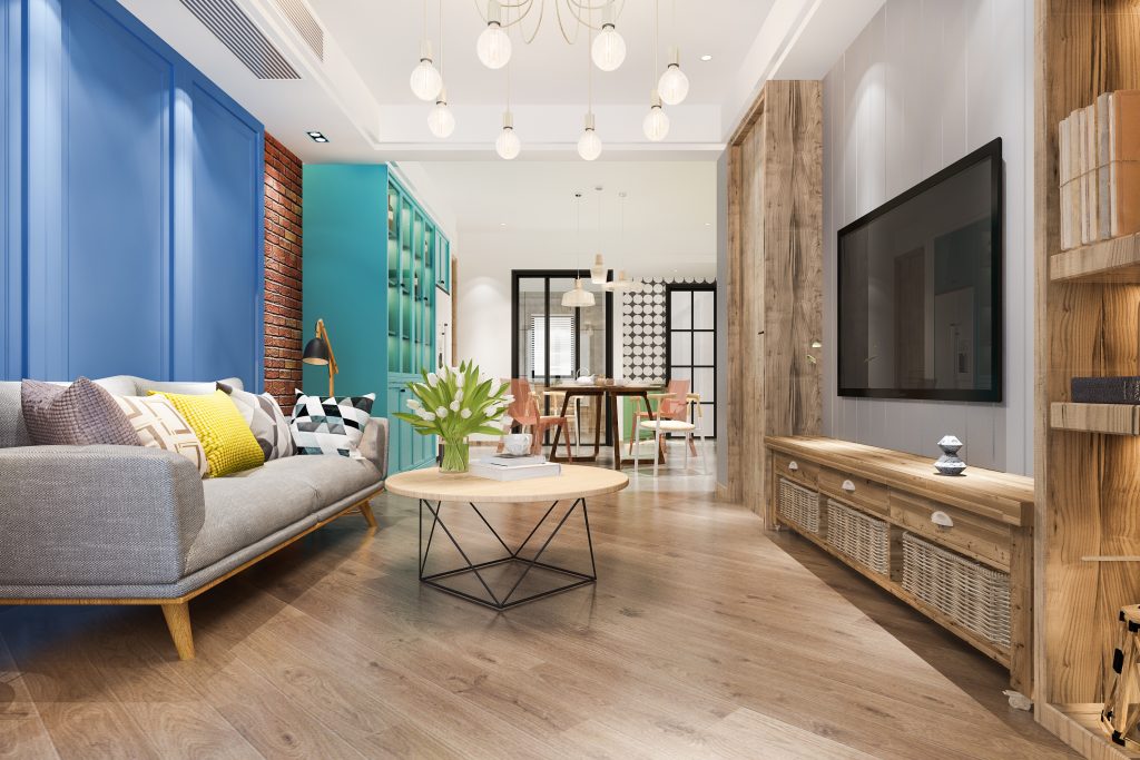 A living room with blue walls and wooden floors.