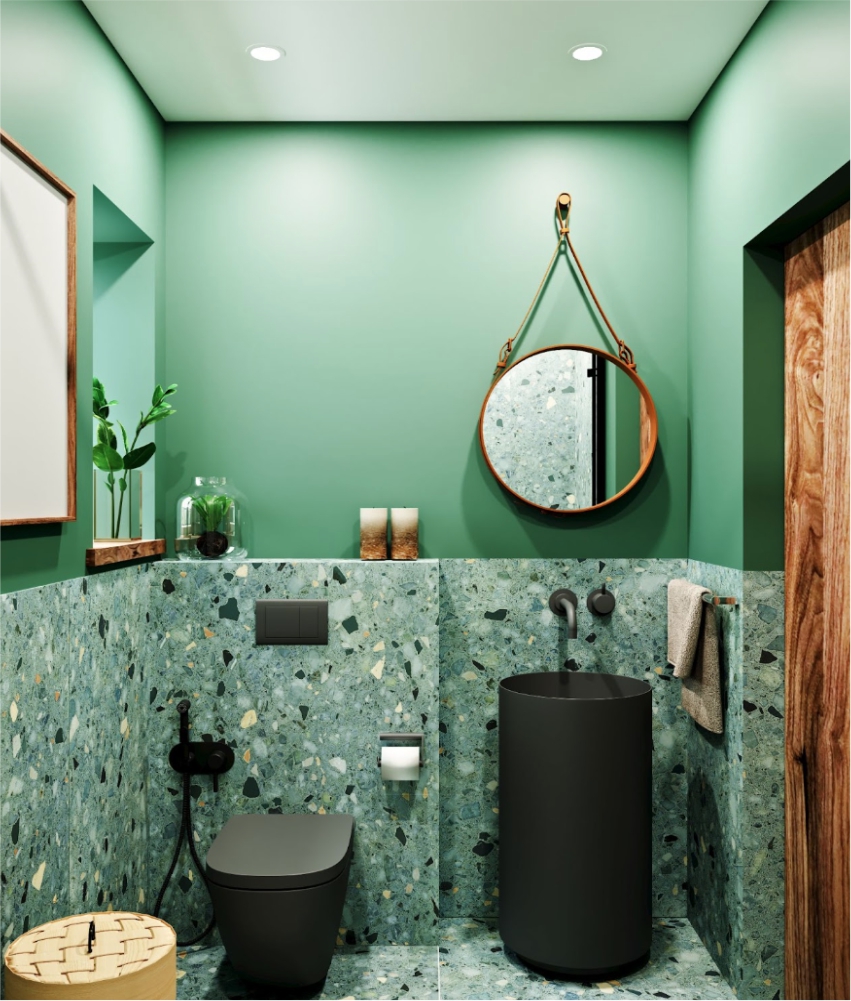 A bathroom with green walls and a black toilet.