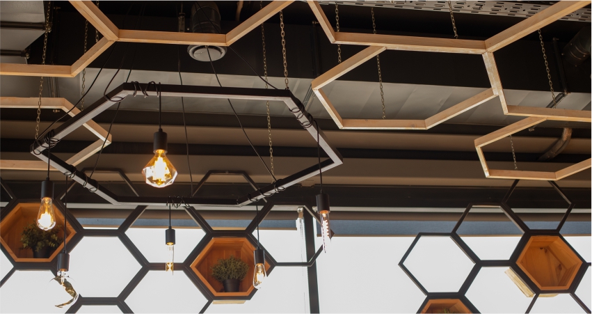 A restaurant with wooden hexagons hanging from the ceiling.