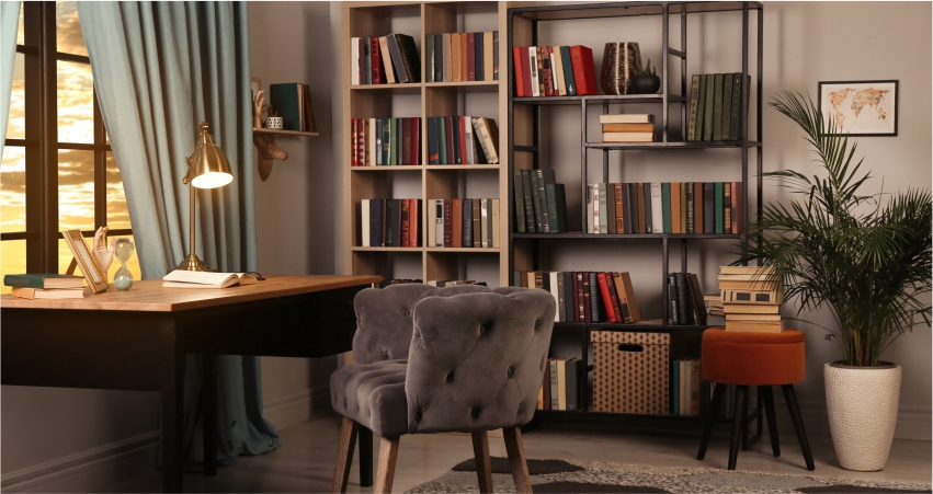 A room with study space, bookshelves and a chair.