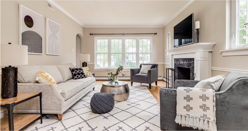 A living room with couches and a fireplace.