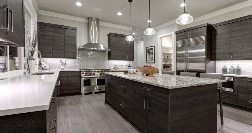 A modern kitchen with dark wood cabinets and stainless steel appliances.