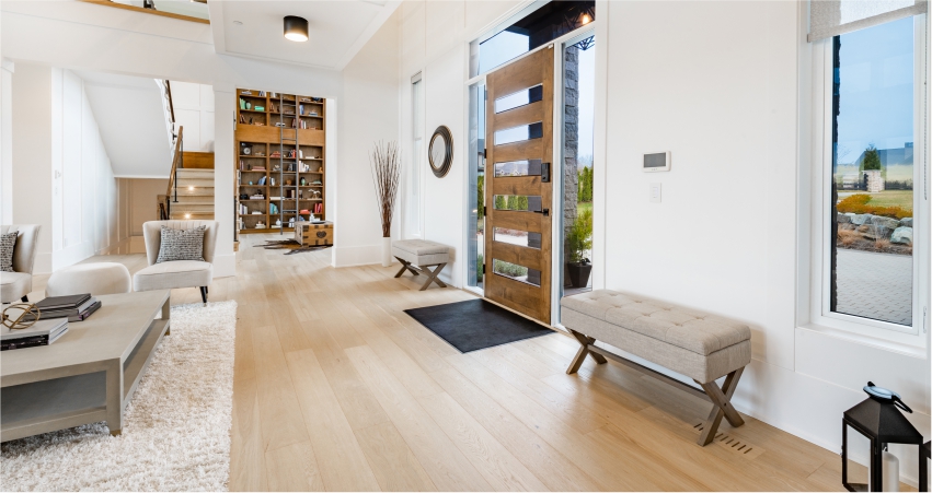 A modern living room with hardwood floors and a bookcase.