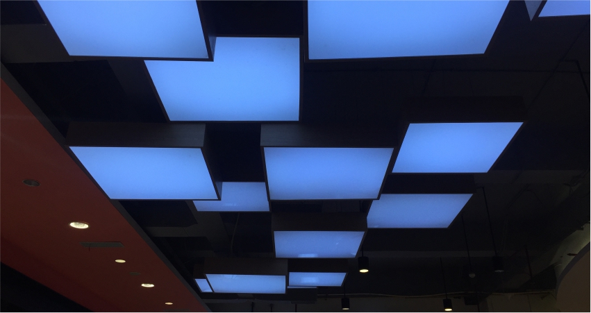 A ceiling with a lot of blue squares on it.