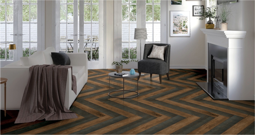 A living room with wood floors and chevron pattern.