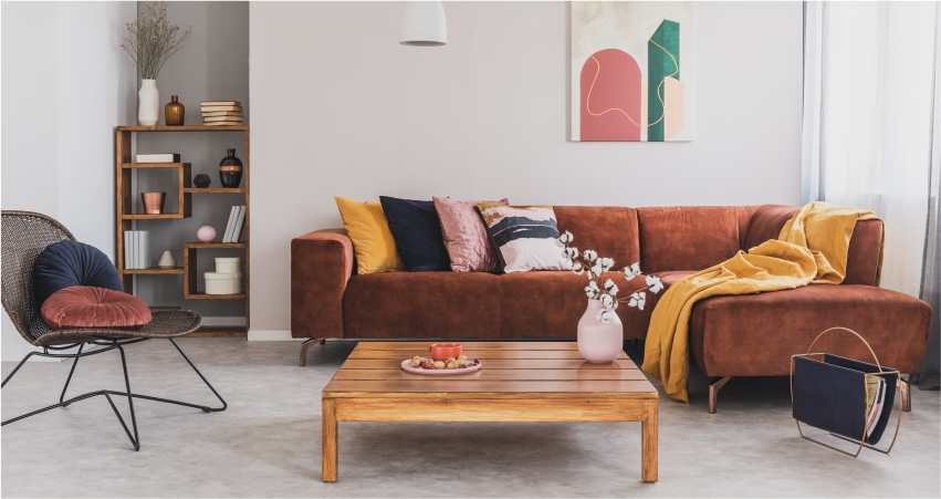 A living room with a brown couch and a coffee table.