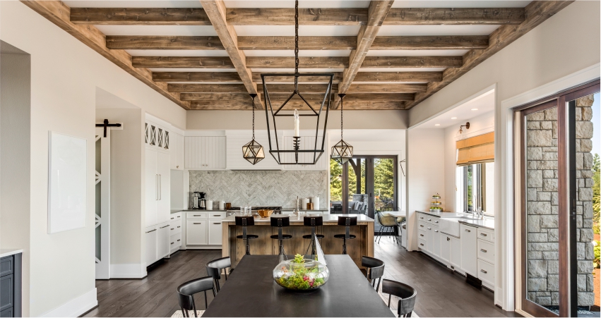 A kitchen with wood beams and a dining table.