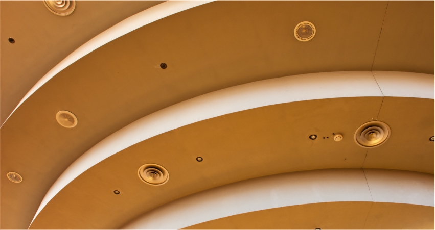 A close up of a circular ceiling in a building.