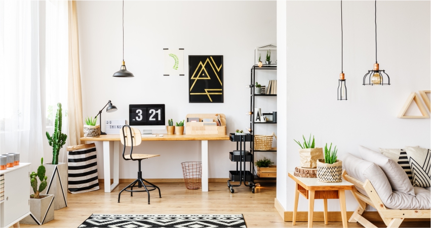 A white and black living room with a black and white rug, study space, and wooden furniture.