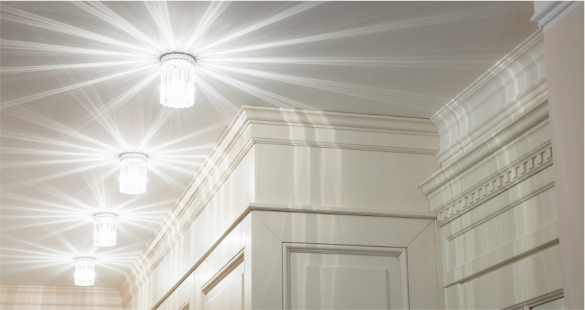 A hallway with a light shining from the ceiling.