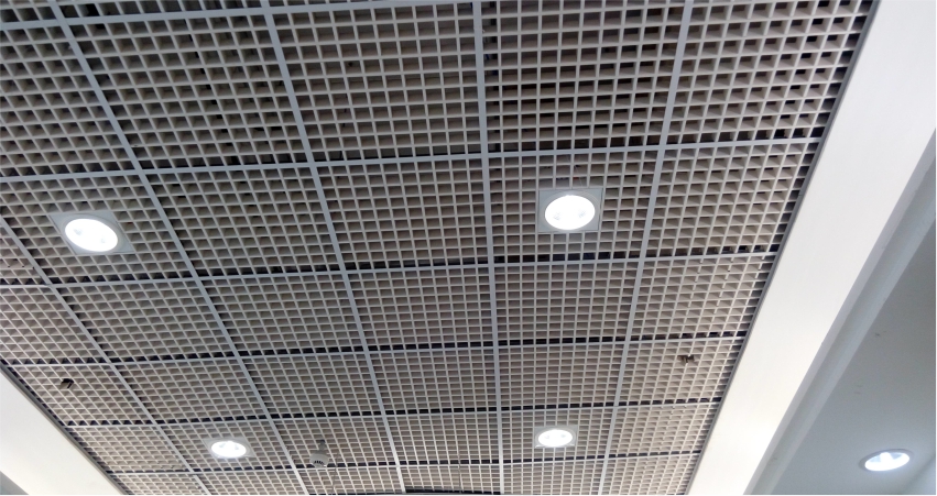 A ceiling with metal grids and lights.