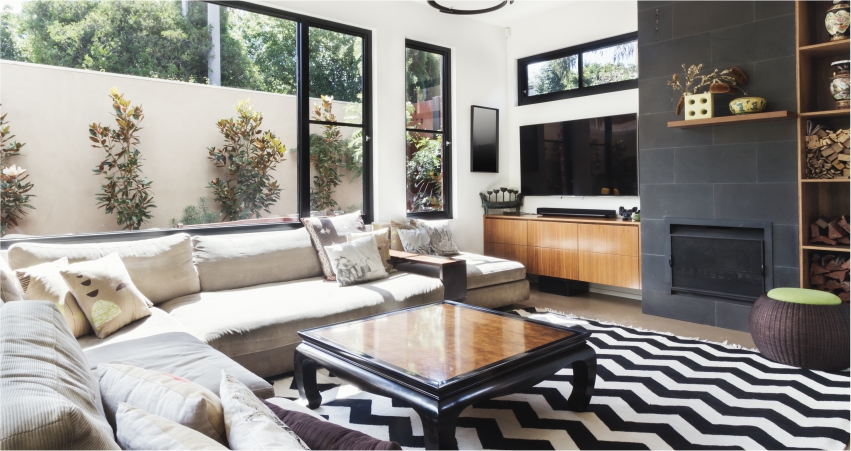 A living room with a black and white chevron rug.
