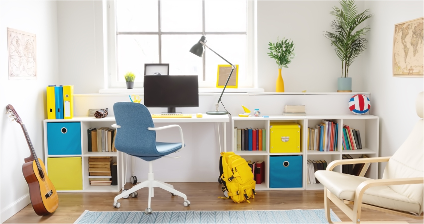 A child's room with a study desk, bookshelves, and a guitar.