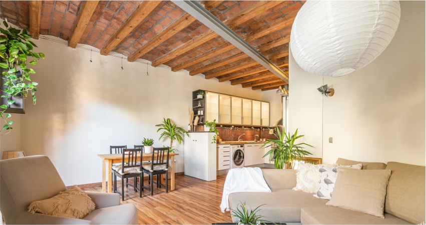 Room with wood-panelled ceiling.