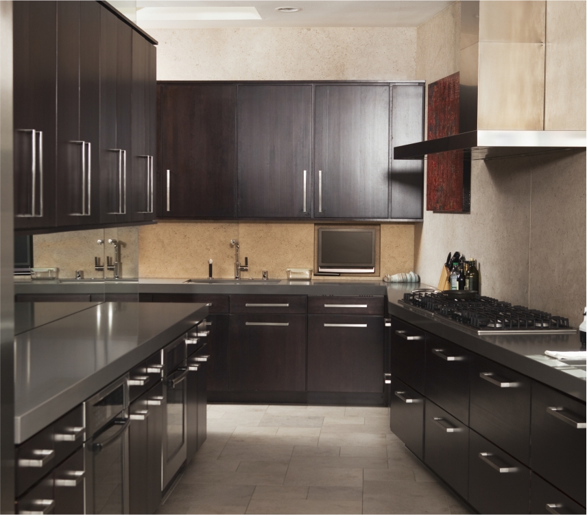 A kitchen with dark brown cabinets and stainless steel appliances.