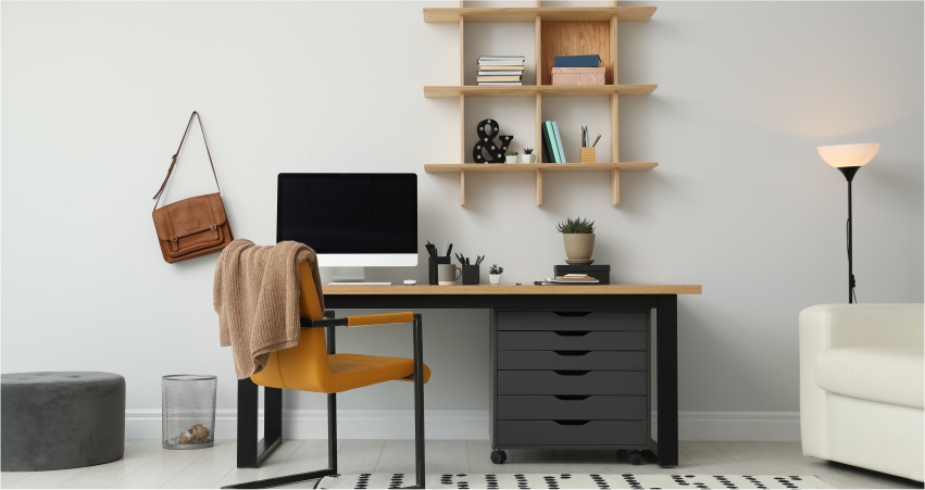 A home office with a desk, chair and bookshelf.