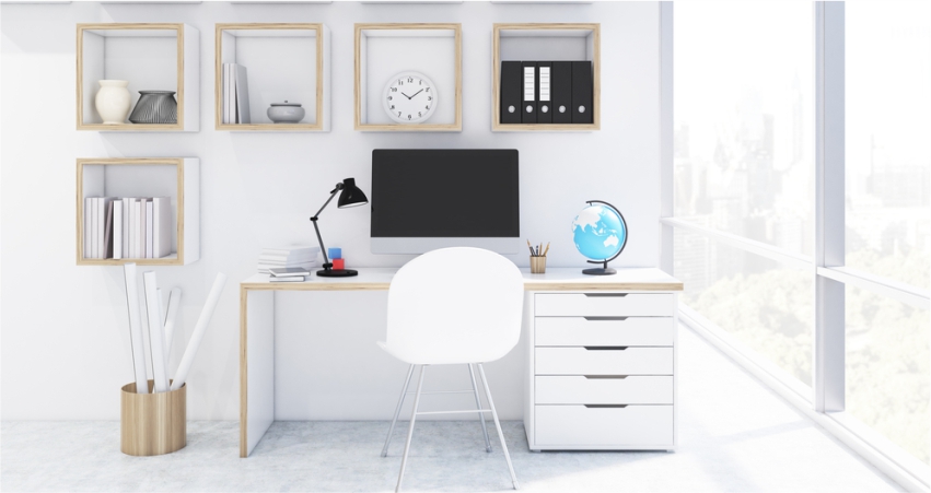 A white office with a desk and bookshelves.
