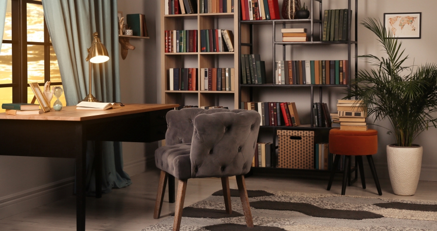 A home office with bookshelves and a chair.