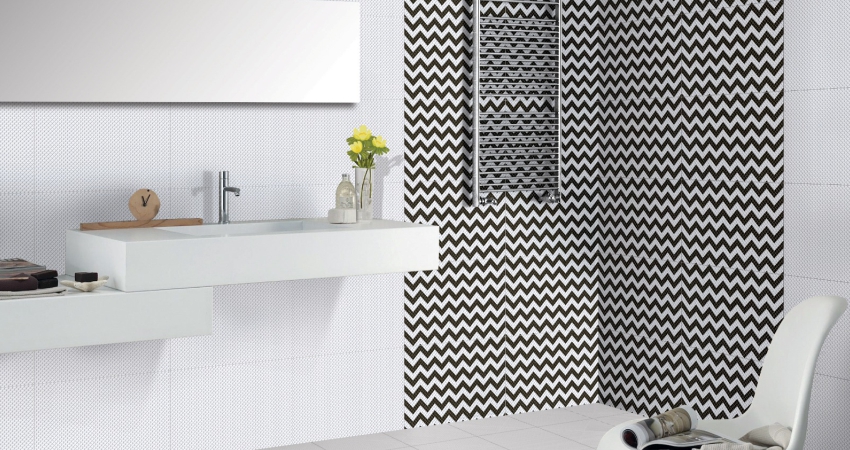 A bathroom with black and white chevron tiles.