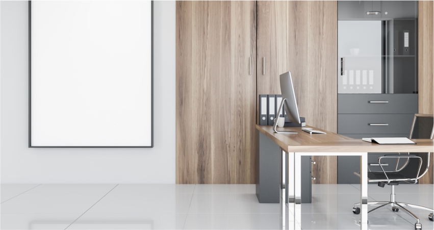 A modern office with a wooden desk and a large poster.