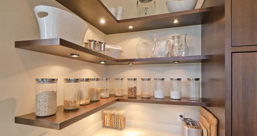 A kitchen with a lot of shelves and jars.
