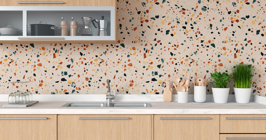 A kitchen with colorful splatters on the wall.